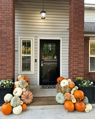 Front porch pumpkin arrangement featuring white, orange, and blush pumpkins in orlando florida